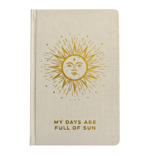 Creamy ivory gratitude journal with gleaming gold sun design and gilded page edges