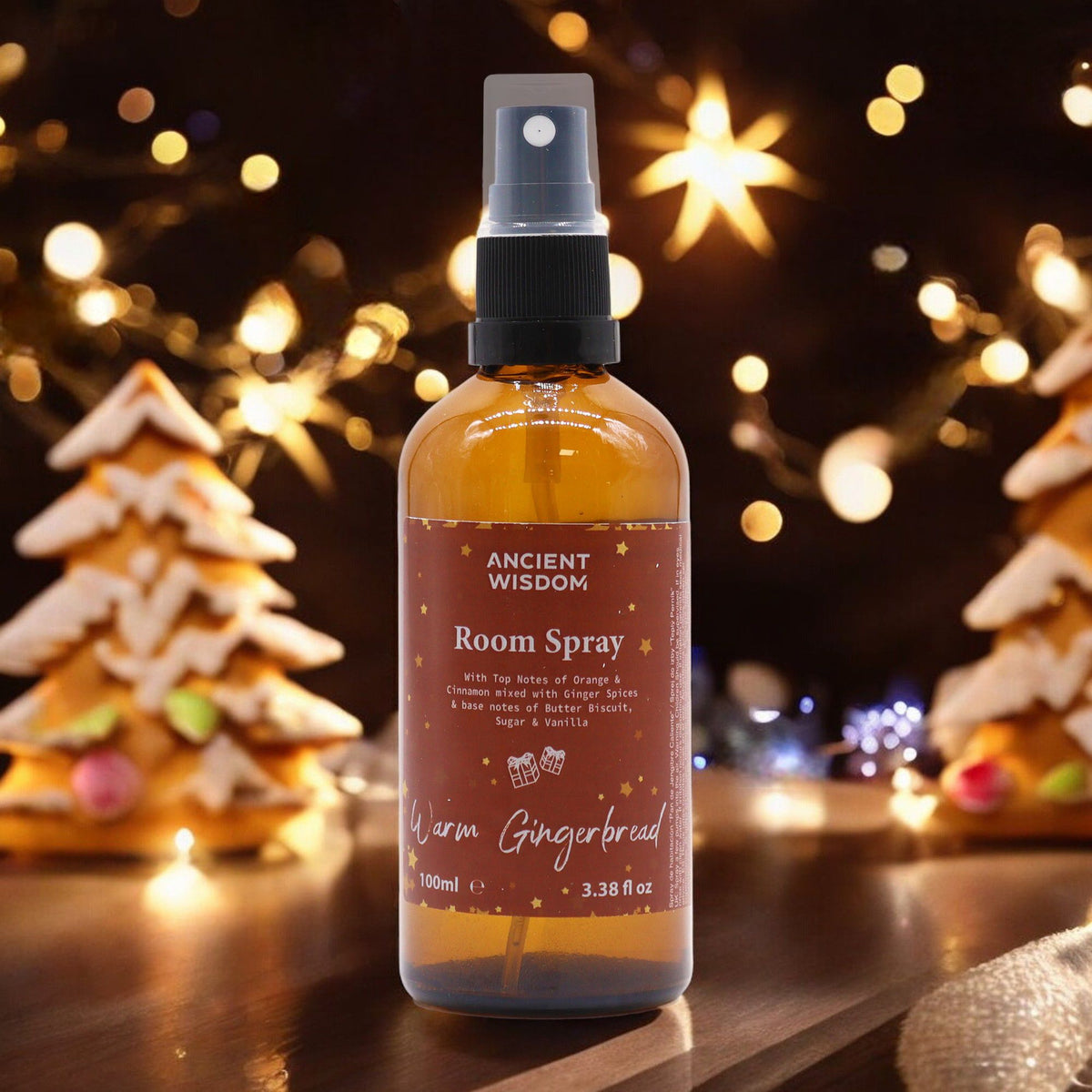 100ml Warm Gingerbread room spray bottle with gingerbread men, cinnamon sticks and orange slices on cosy Christmas kitchen background