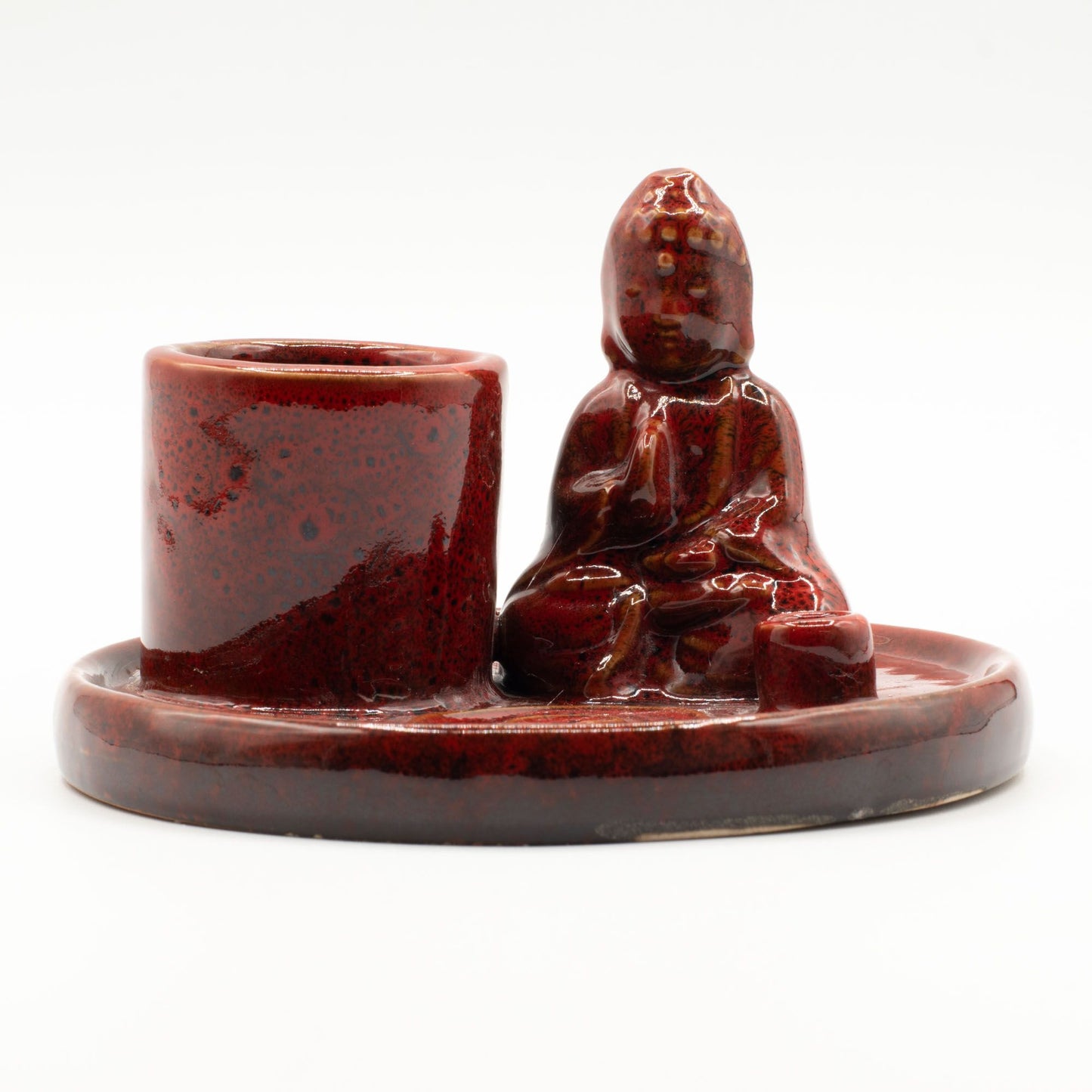 Ceramic incense burner with a sitting Buddha on a white background