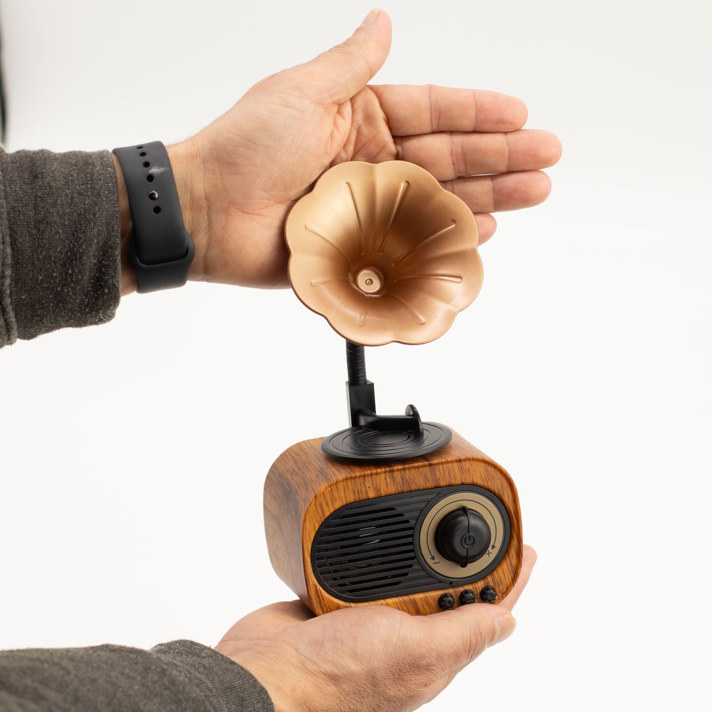 Small wooden gramophone speaker held in a hand