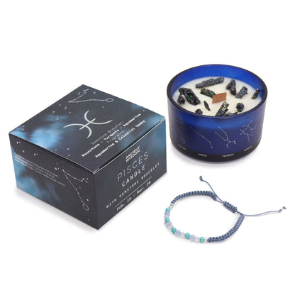 Soft aqua Pisces zodiac candle burning beside delicate moonstone, turquoise & aquamarine bracelet, styled with seashells