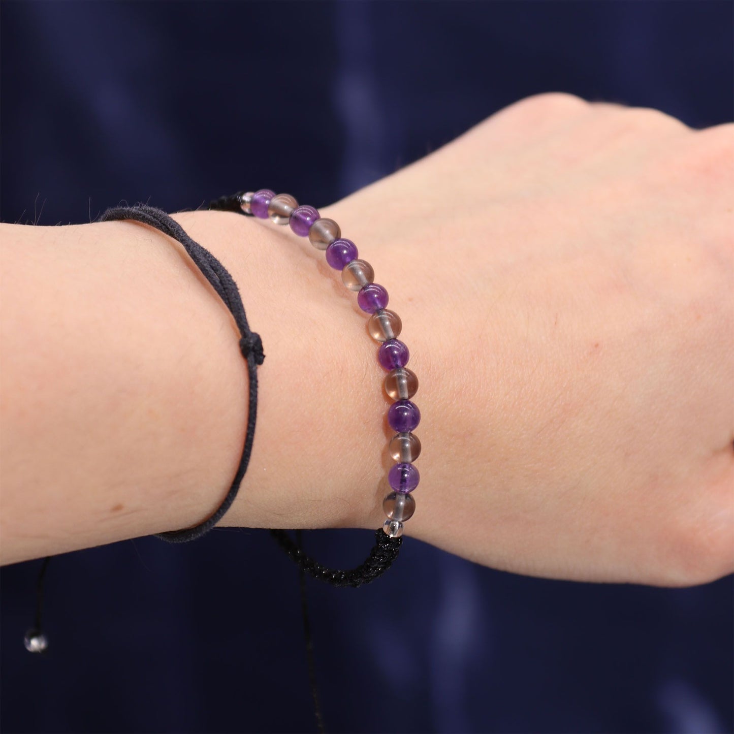Beaded bracelet with purple and black beads on a wrist