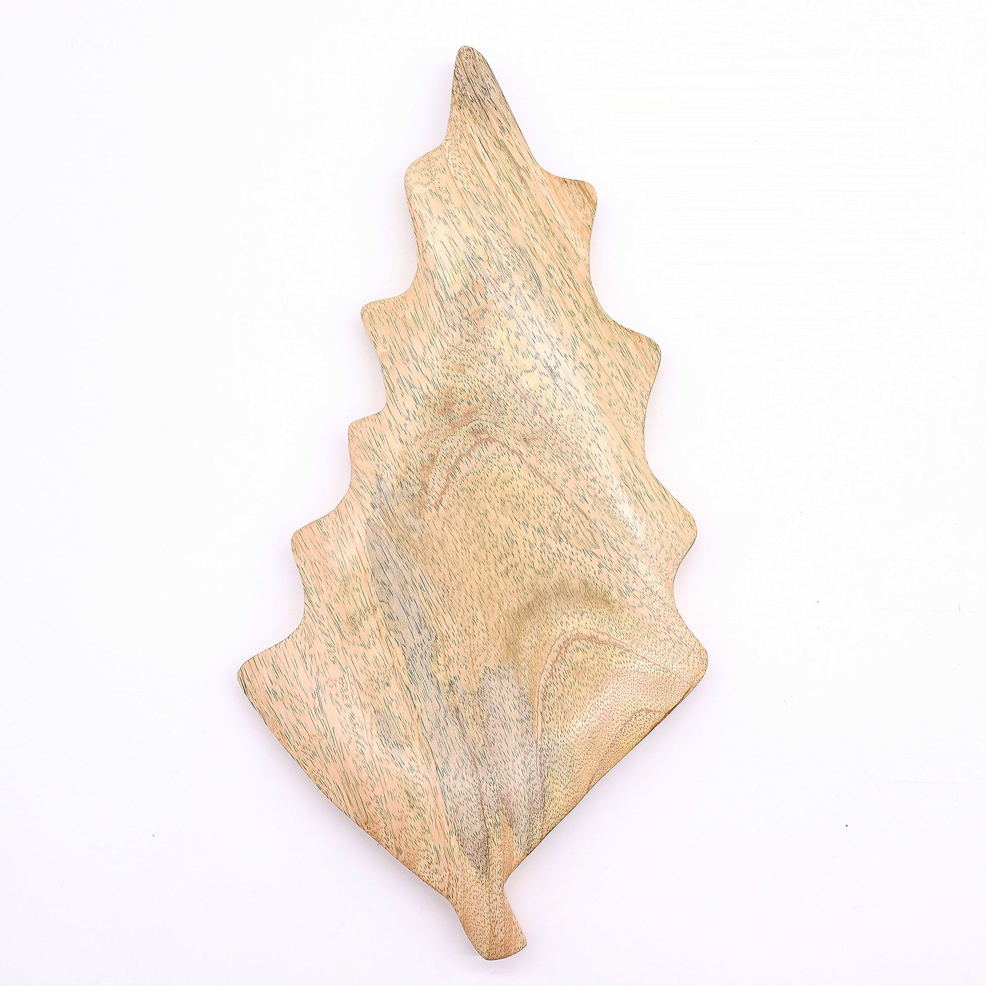 Large leaf-shaped mango wood bowl with rich green enamel inside, filled with pine cones and candles on autumn table setting