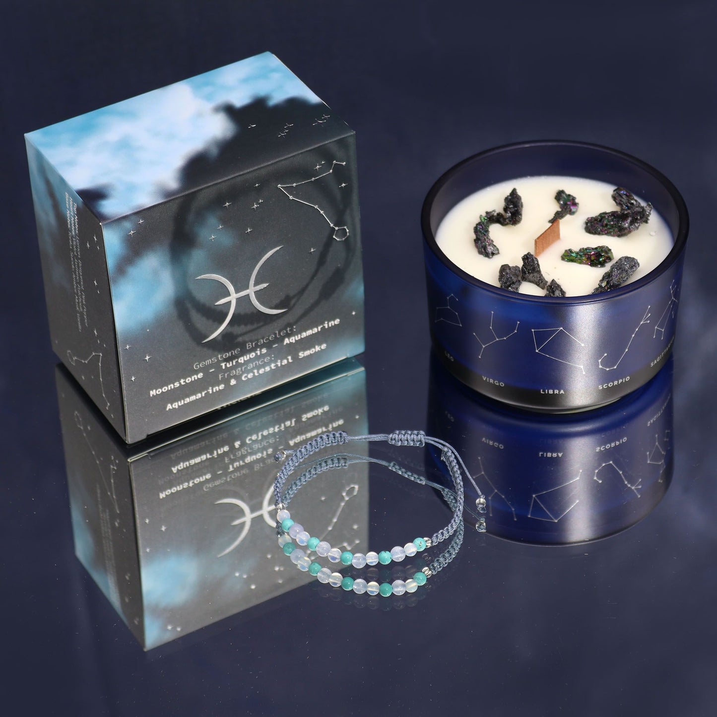 Candle in a blue container with a bracelet on a reflective surface