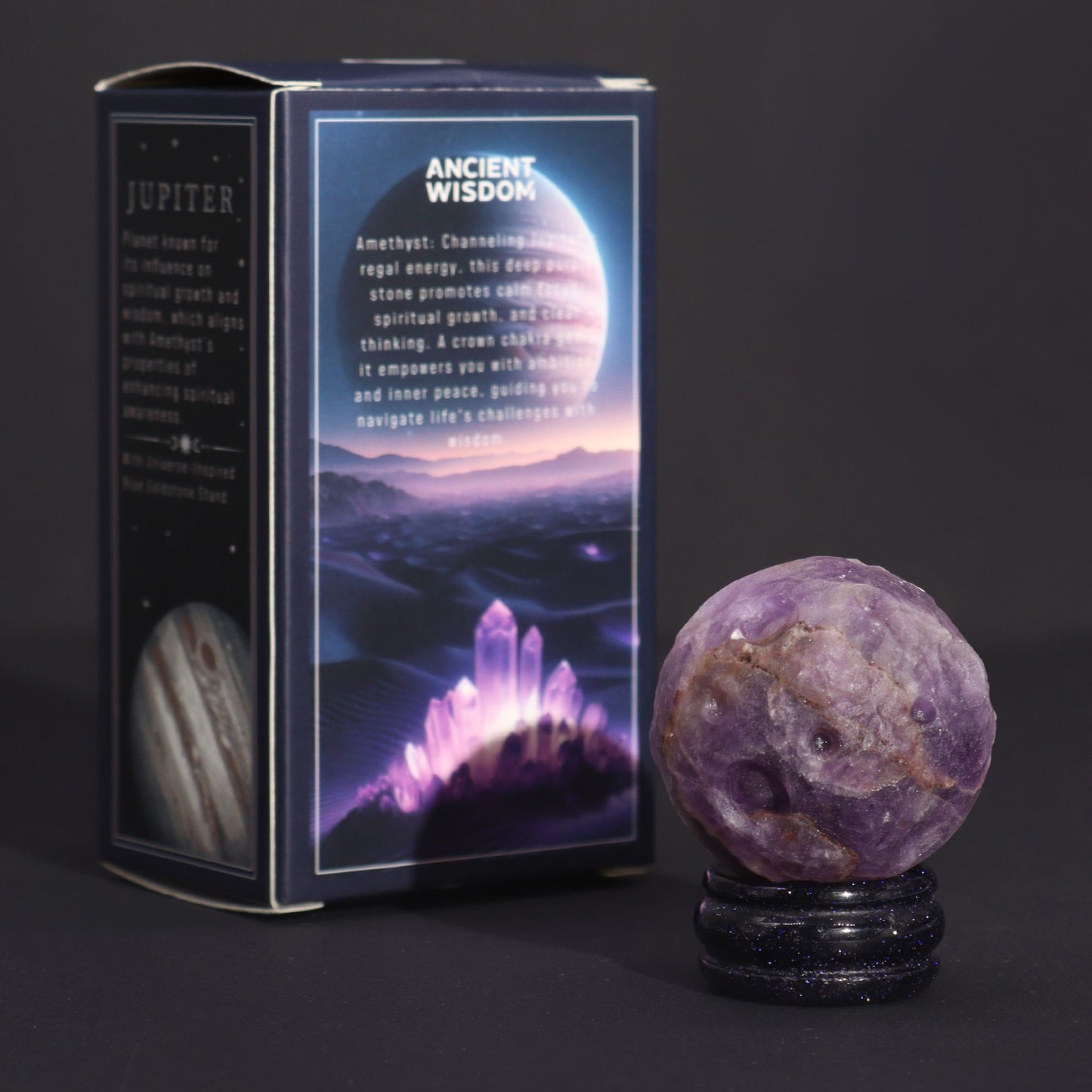 Rich purple 40mm Amethyst Jupiter sphere floating on glittering goldstone ring stand, regal cosmic background with soft golden light
