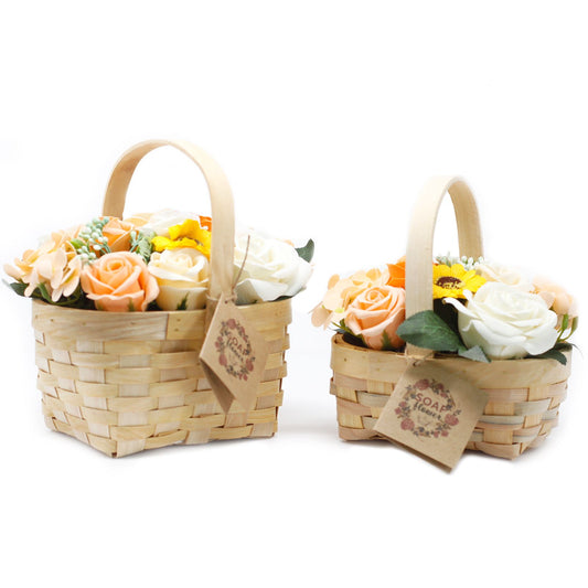 Two small wicker baskets with soap floral arrangements on a white background