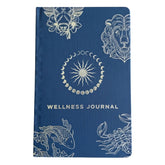 Deep midnight blue wellness journal with silver foil zodiac constellations, open to colourful mood wheel page