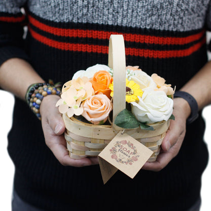 Person holding a basket of soap flowers with a decorative tag