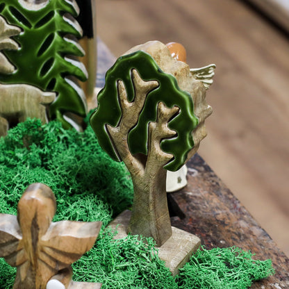 20 cm tall 3D mango wood Christmas tree with deep green enamel branches on wooden base, styled on shelf with fairy lights and pine cones