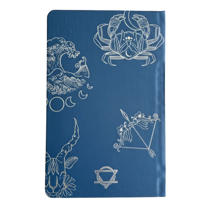 Deep midnight blue wellness journal with silver foil zodiac constellations, open to colourful mood wheel page
