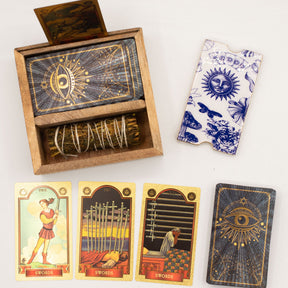 Wooden box with tarot cards, a deck of cards, and tarot card boxes