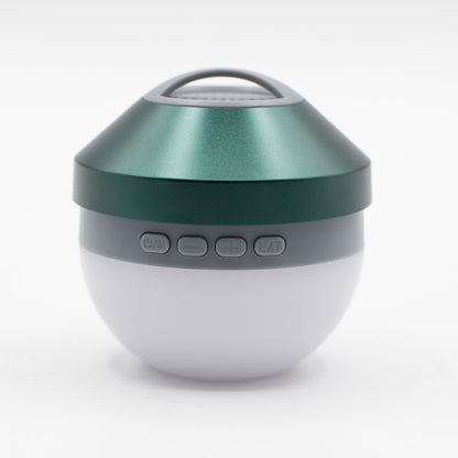 Close-up of green mini speaker showing integrated controls, 40mm speaker grille, LED light ring and hang loop detail