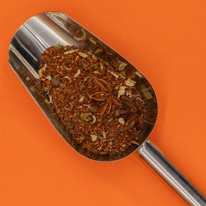 50g tin of Red Bush Digestive rooibos tea with warm orange & gold label, loose leaves with fennel seeds, mint leaves and anise stars