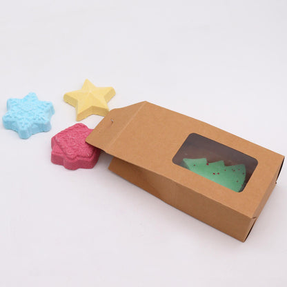 Christmas Wish List bath bomb gift pack with snowflake, gold star, green tree and gingerbread house bombs in elegant kraft box with gold ribbon