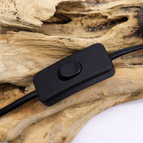 Grey Luna textured sphere glowing softly atop twisted driftwood base