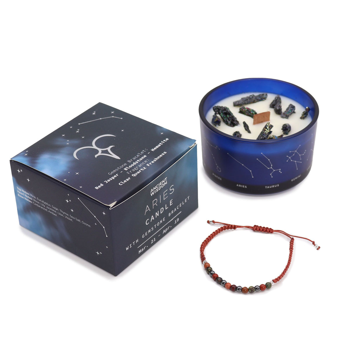 Bold red Aries zodiac candle burning beside matching red jasper, bloodstone & hematite bracelet, styled with ram symbol, pine branches and Aries constellation card