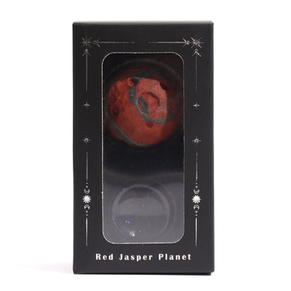 40mm deep red Jasper Mars sphere dramatically lit on sparkling goldstone ring stand against dark cosmic background with fiery glow