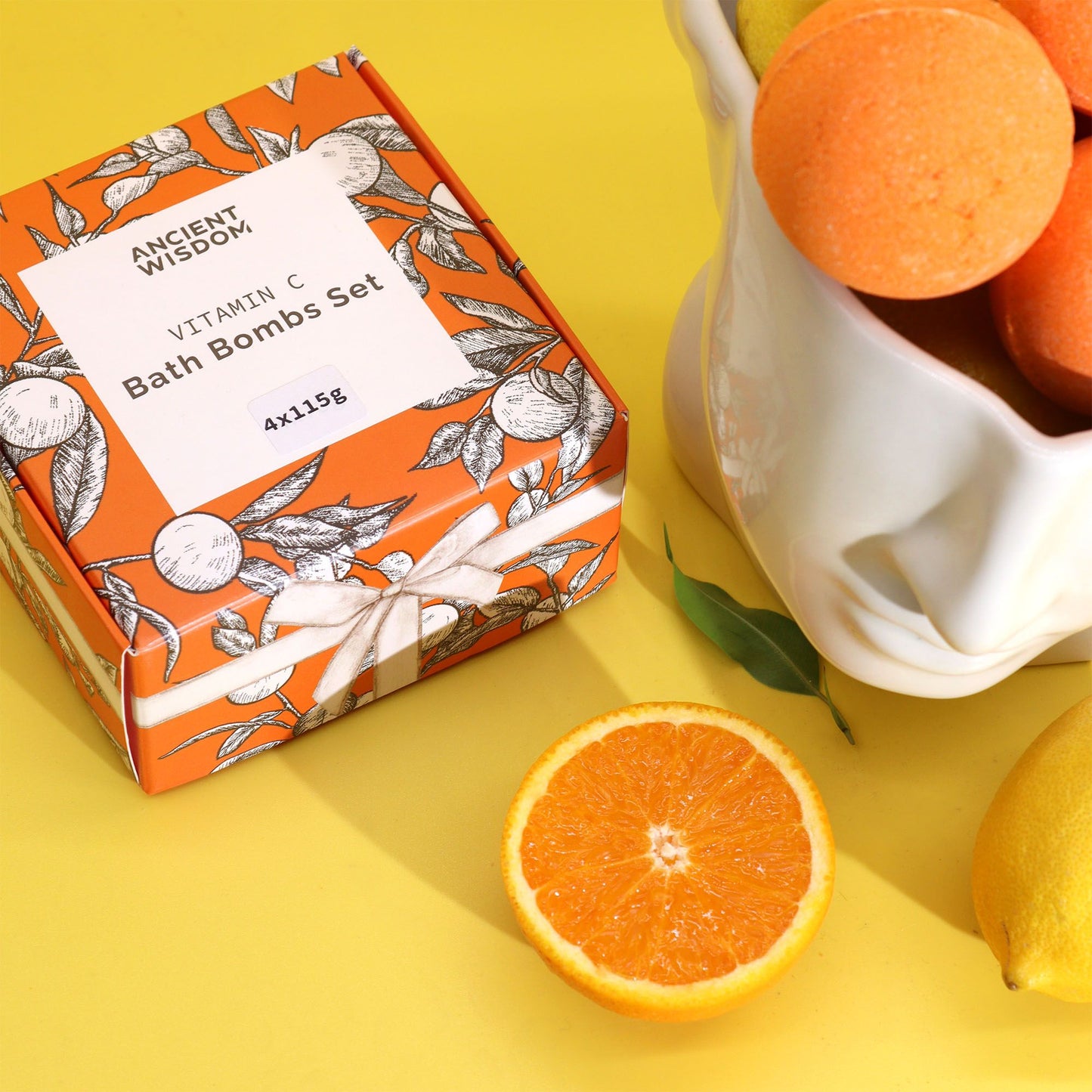 Box of Ancient Wisdom Vitamin C Bath Bombs Set with oranges on a yellow background