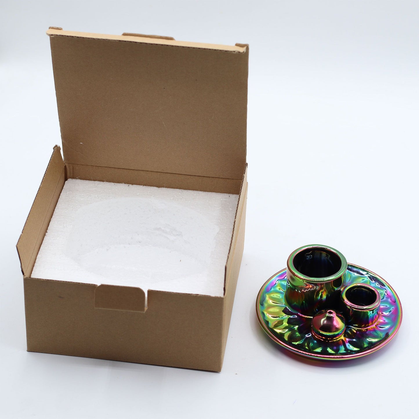 Colorful ceramic incense holder with an open cardboard box.