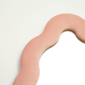 Close-up of rose blush velvet texture on chunky frame, showing plush finish and subtle squiggly pebble edge detail