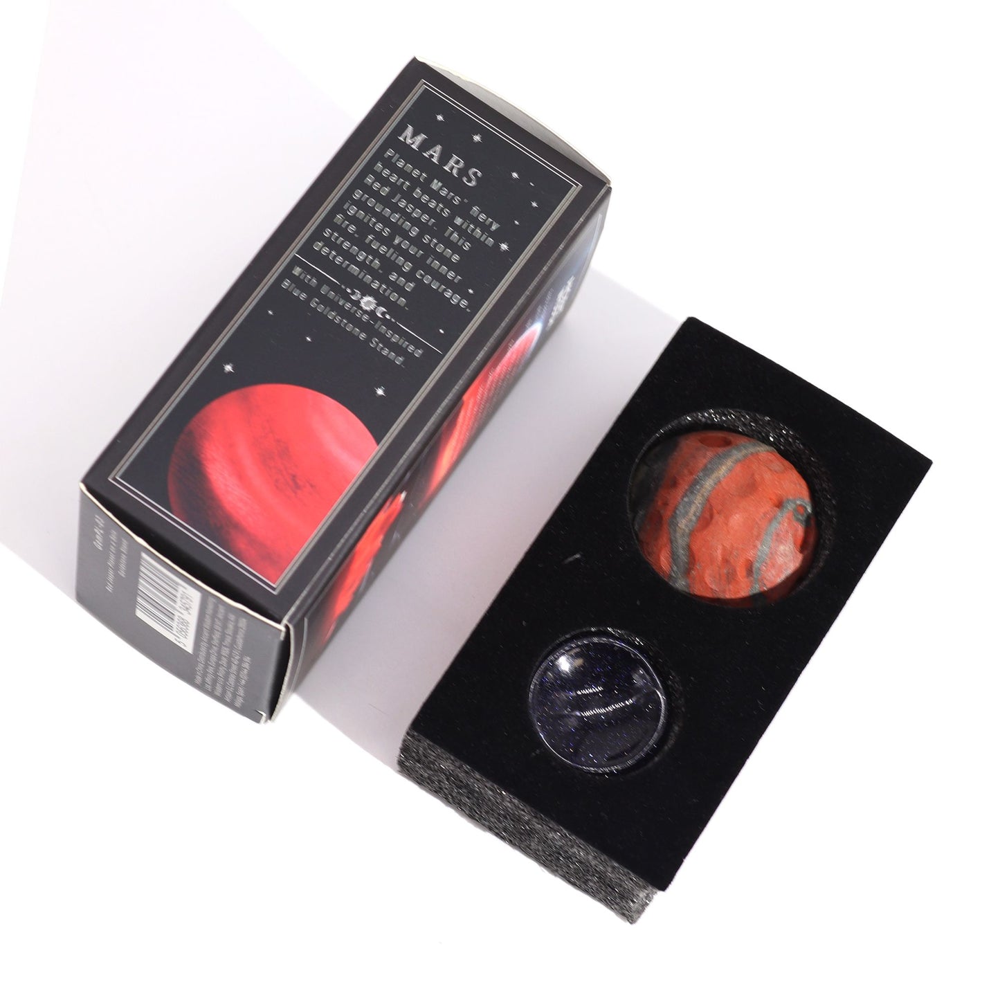 40mm deep red Jasper Mars sphere dramatically lit on sparkling goldstone ring stand against dark cosmic background with fiery glow