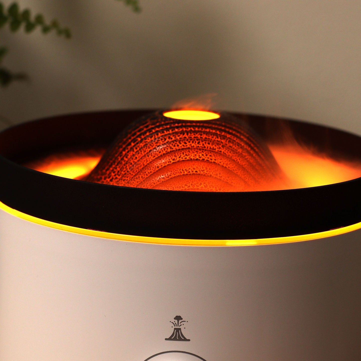 Large black volcano aroma diffuser erupting with swirling coloured mist and glowing LED ring