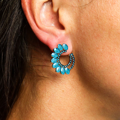 Close-up of an ear wearing a turquoise earring