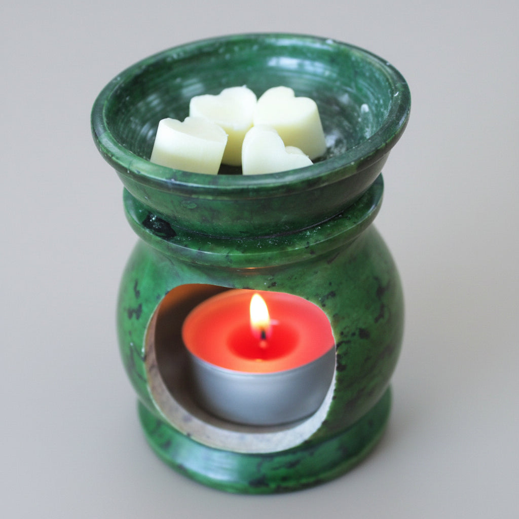 Green ceramic oil burner with wax heart shape cubes and a candle