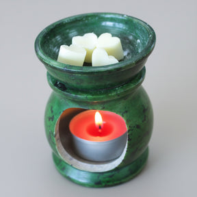 Green ceramic oil burner with wax heart shape cubes and a candle