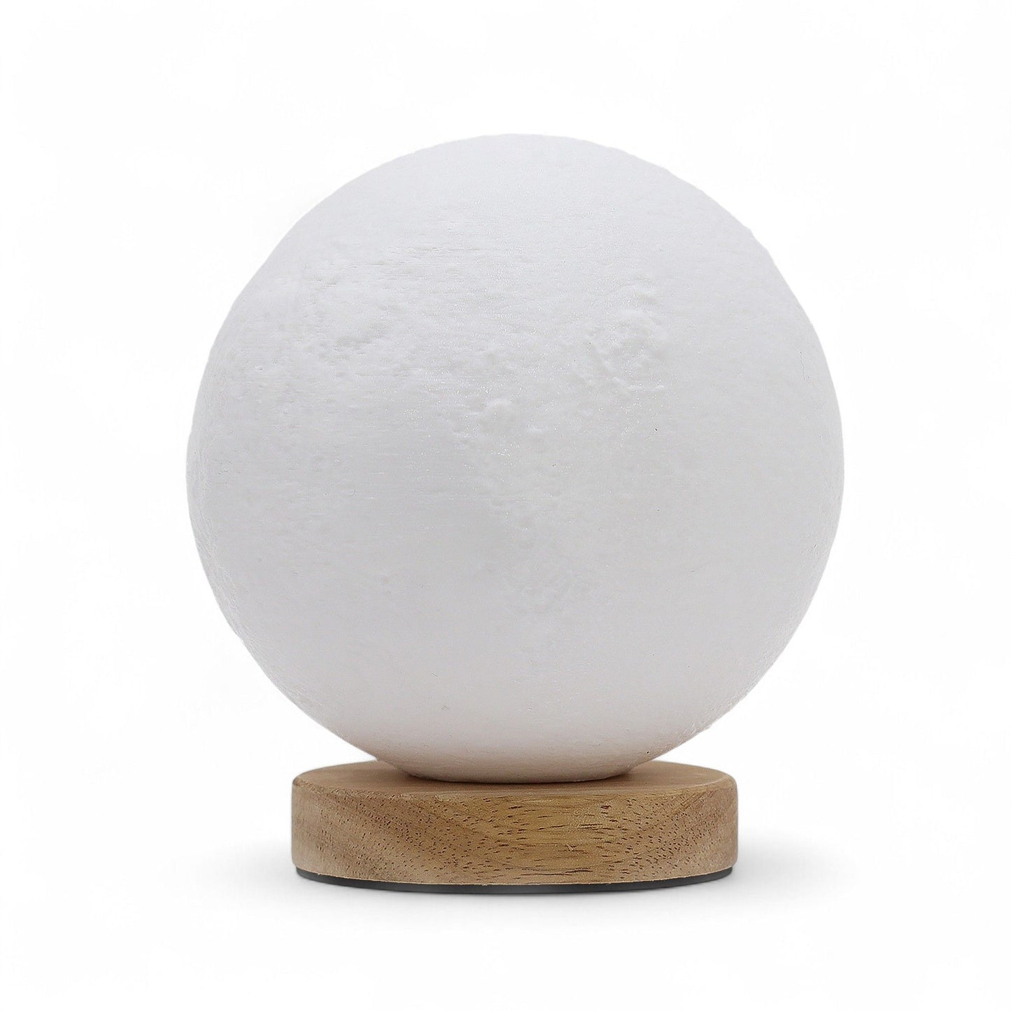 Moon New Wave USB lamp with textured honeycomb surface and crescent moon-inspired shape, warm glow on 3rd brightness setting, placed on wooden base