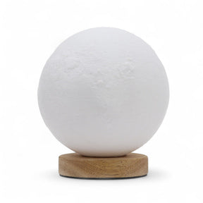 Moon New Wave USB lamp with textured honeycomb surface and crescent moon-inspired shape, warm glow on 3rd brightness setting, placed on wooden base