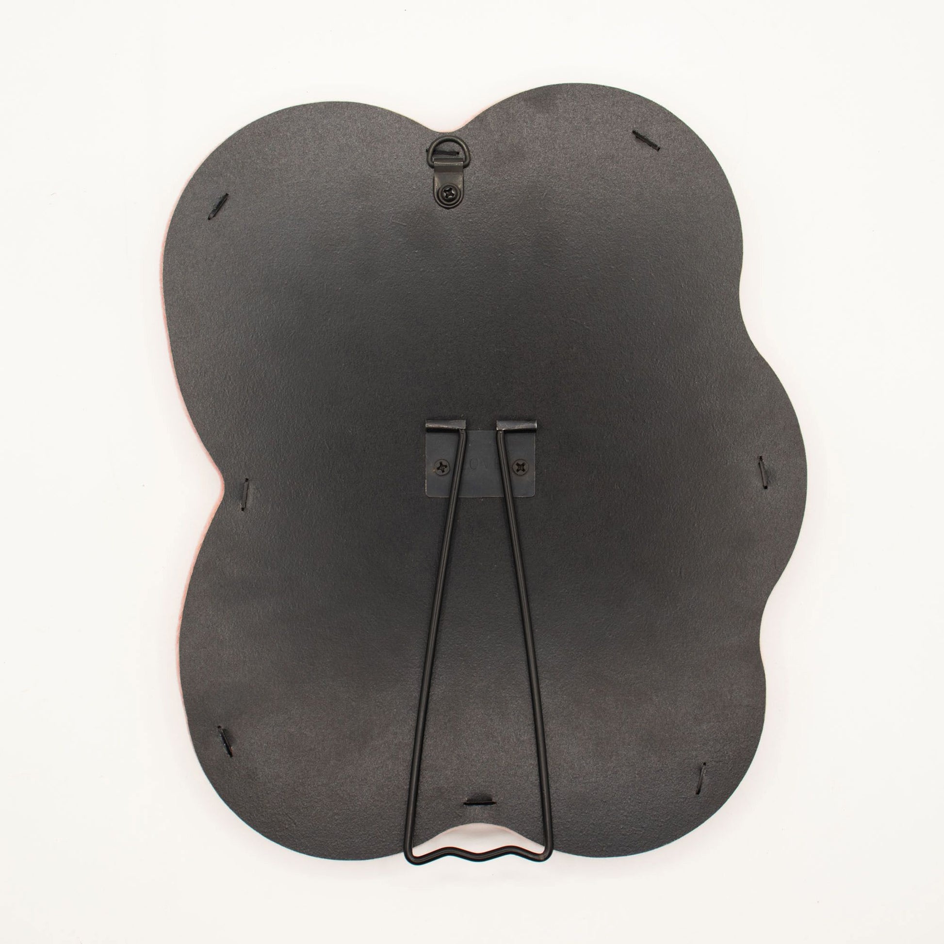 Detail of built-in stand on back of mirror for tabletop use, sturdy MDF construction visible