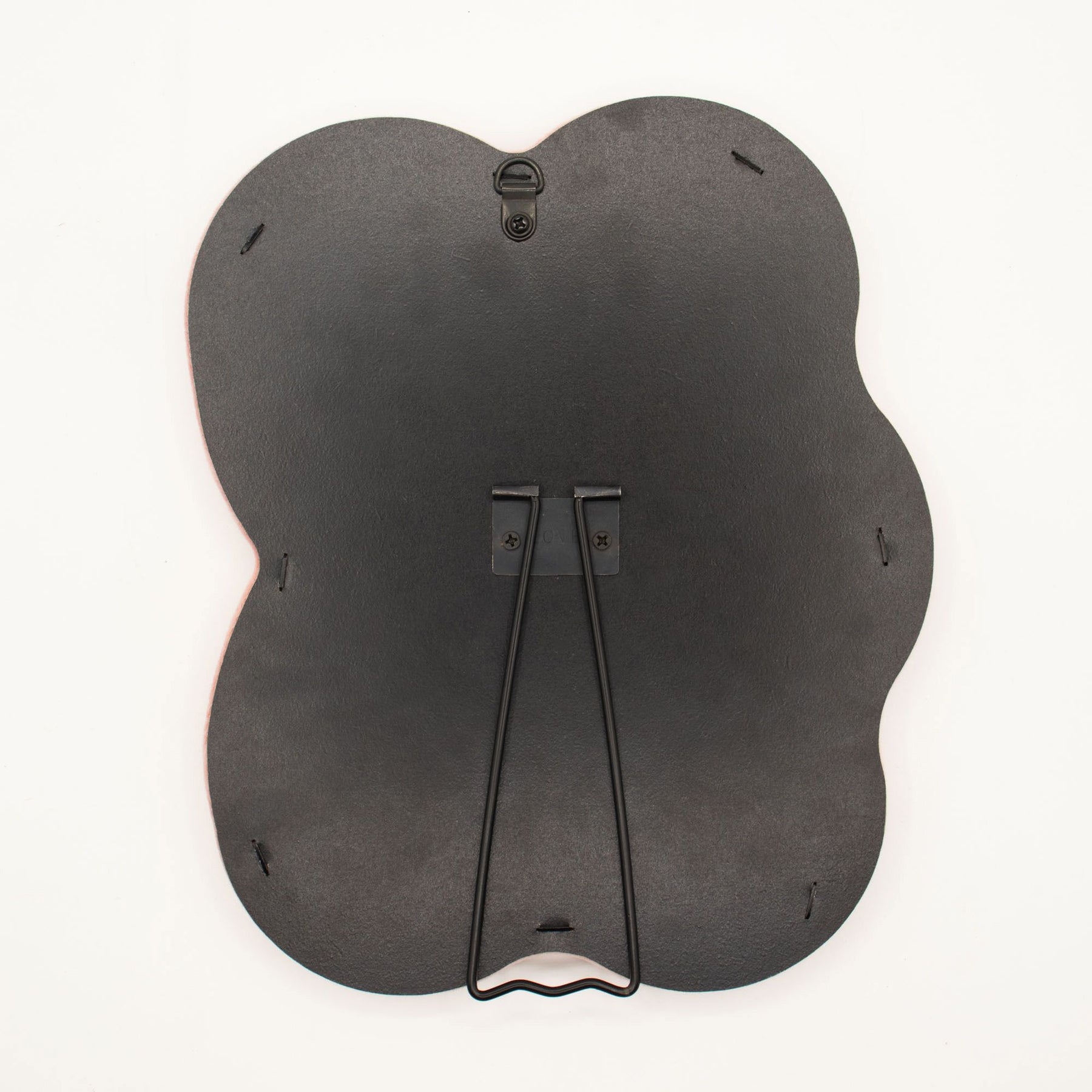 Detail of built-in stand on back of mirror for tabletop use, sturdy MDF construction visible
