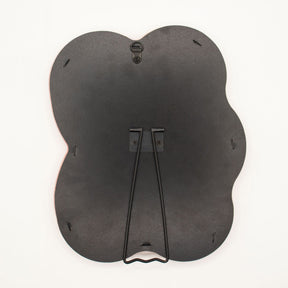 Detail of built-in stand on back of mirror for tabletop use, sturdy MDF construction visible