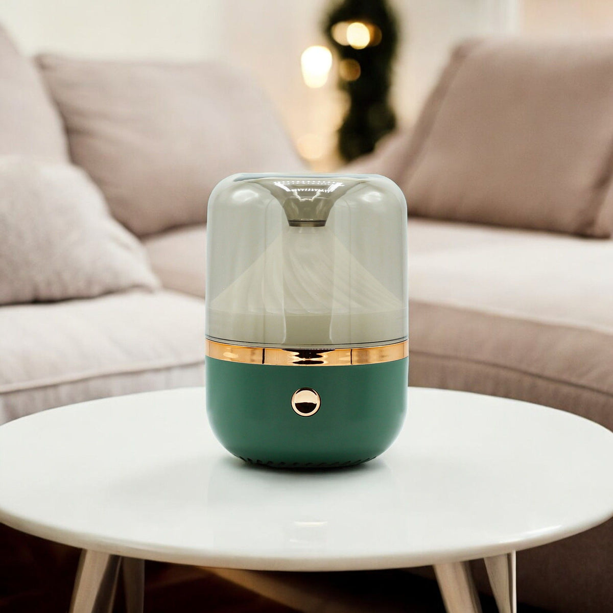 Green and gold humidifier on a white table with a blurred sofa in the background