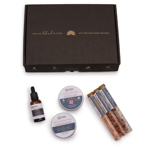 Serenity Essential Self Care Kit in elegant gift box open to reveal strawberry scrub jar, body cream, three bath salt vials, Vitamin C serum dropper bottle, fresh strawberries and lavender sprigs on marble