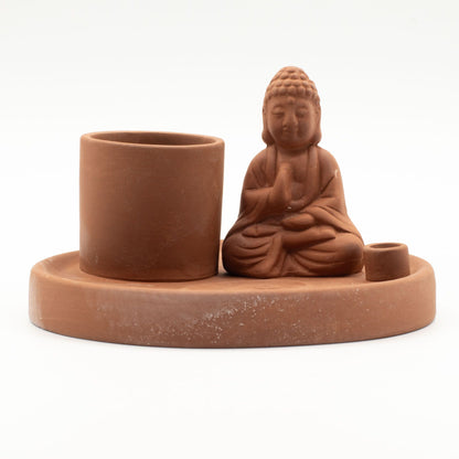 Terracotta Buddha incense holder with cup and candle holder on a white background