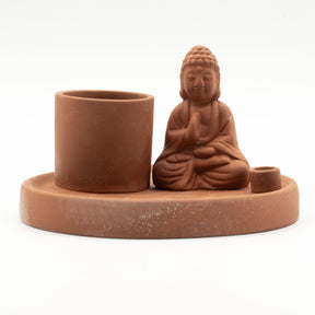 Terracotta Buddha incense holder with cup and candle holder on a white background