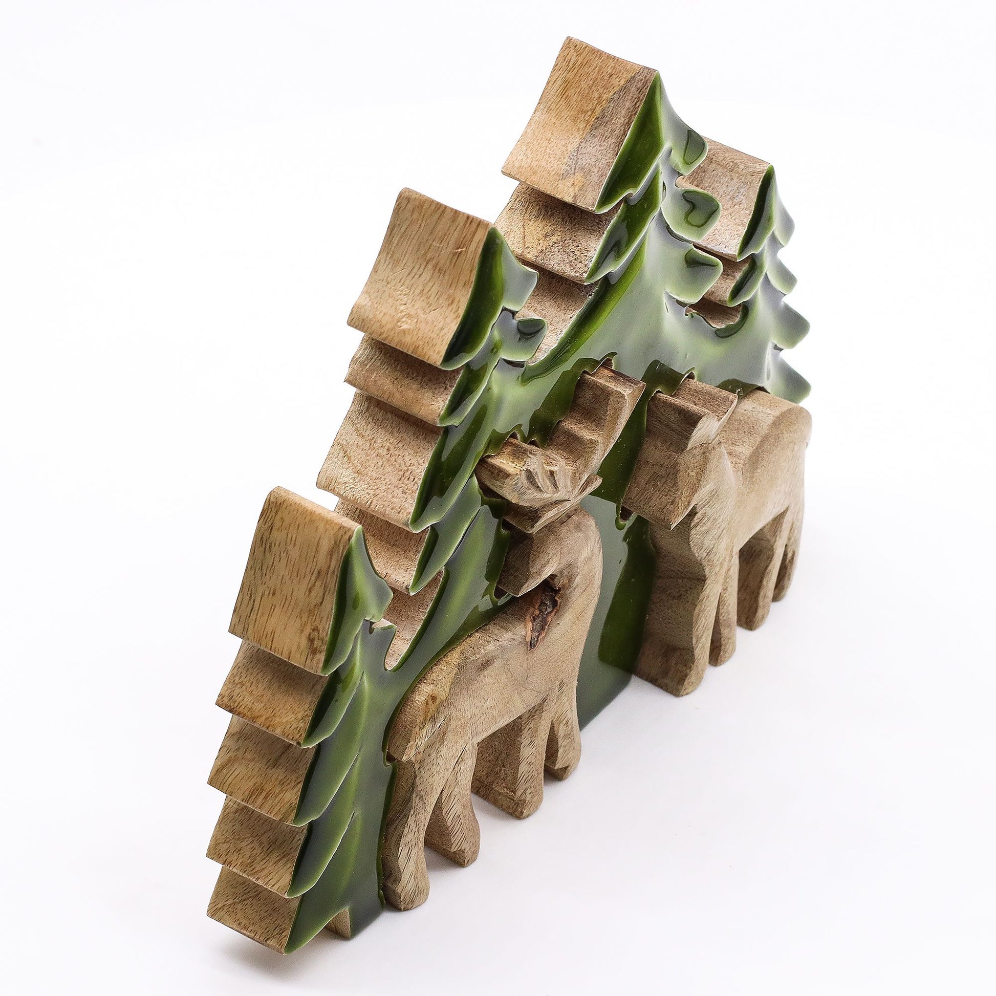 3D mango wood deer in forest decoration with two standing deer, green enamel trees and layered woodland scene on mantel with fairy lights and pine cones