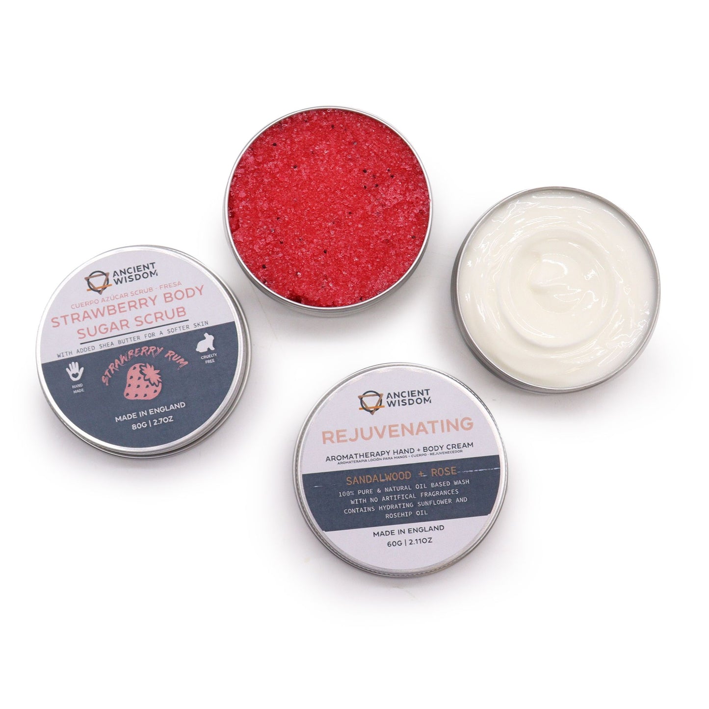 Serenity Essential Self Care Kit in elegant gift box open to reveal strawberry scrub jar, body cream, three bath salt vials, Vitamin C serum dropper bottle, fresh strawberries and lavender sprigs on marble