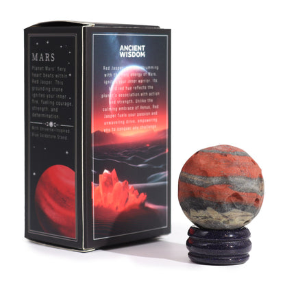 40mm deep red Jasper Mars sphere dramatically lit on sparkling goldstone ring stand against dark cosmic background with fiery glow