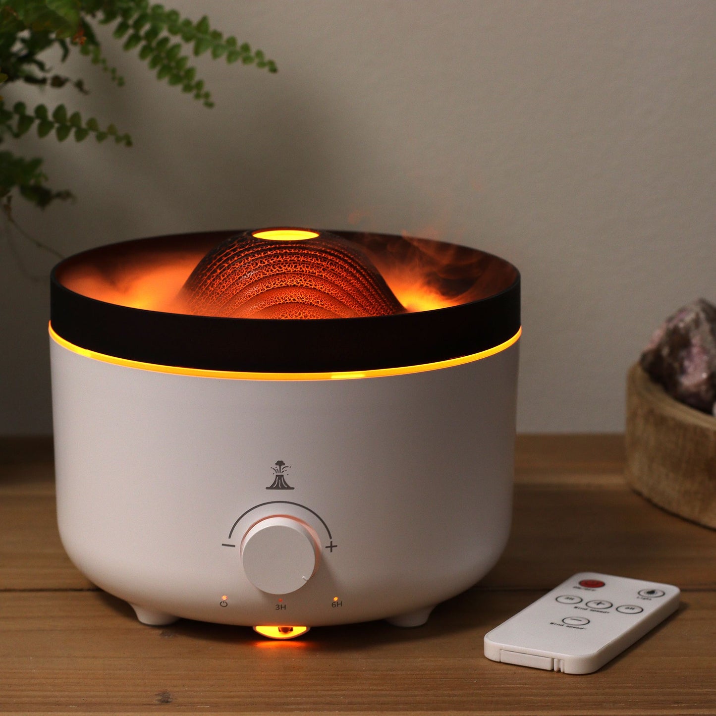 Large black volcano aroma diffuser erupting with swirling coloured mist and glowing LED ring