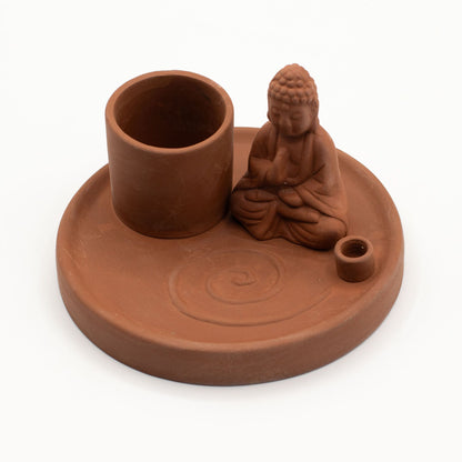Terracotta incense and candle holder with Buddha figure on a white background