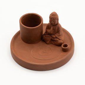Terracotta incense and candle holder with Buddha figure on a white background