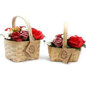 Two small wicker baskets with soap flowers on a white background