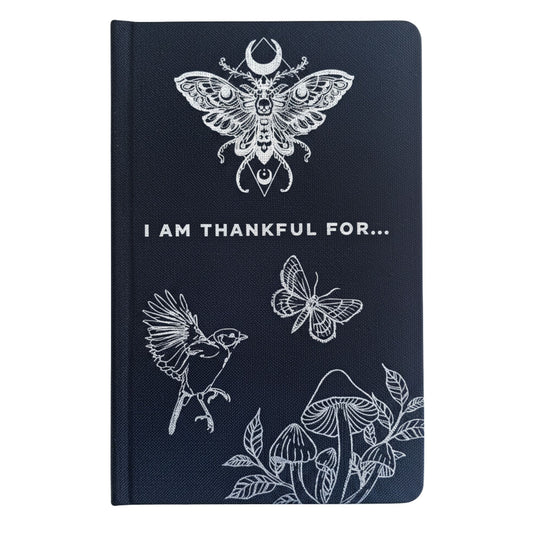 Black hardback gratitude journal with shimmering silver moon, stars & botanicals