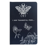 Black hardback gratitude journal with shimmering silver moon, stars & botanicals