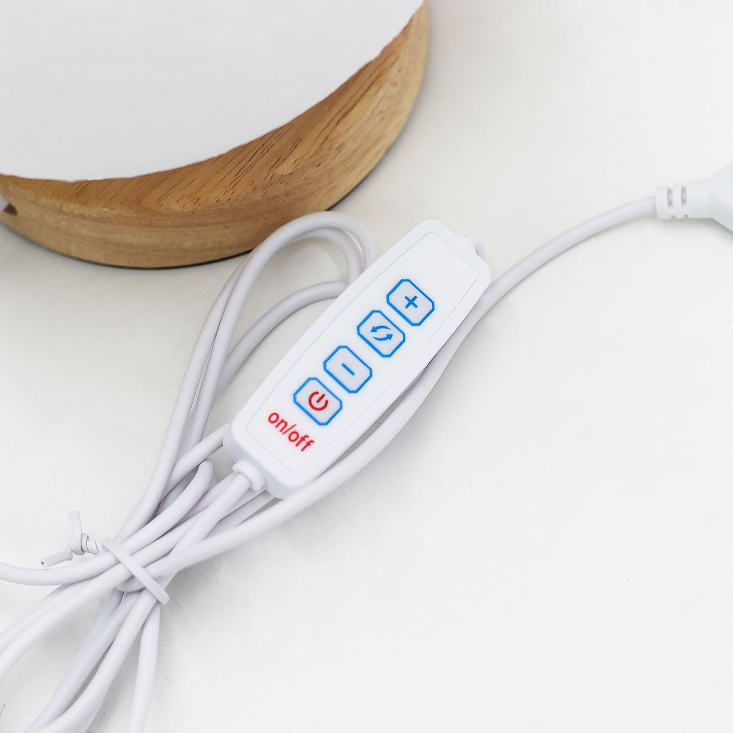 White cable with control panel featuring blue buttons and red 'on/off' label on a light background