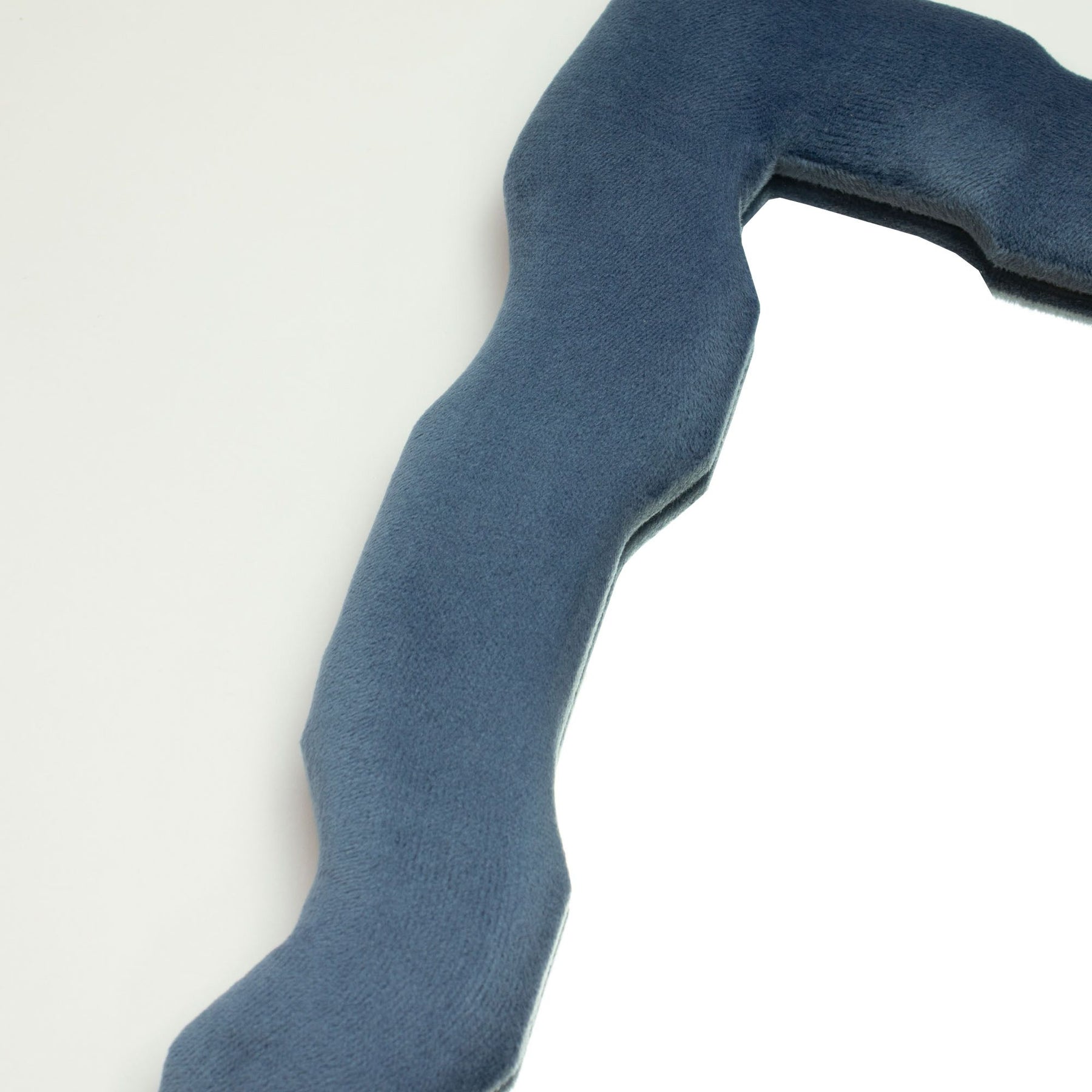 Close-up of royal blue velvet texture on chunky frame, showing plush finish and gentle squiggly edge detail