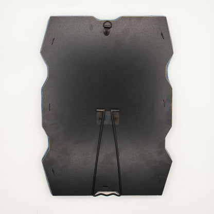 Detail of built-in stand on back of mirror for tabletop use, sturdy MDF construction visible